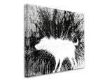 a black and white photo of a sheep in the woods