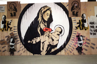 a mural of a woman holding a baby