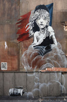 a painting of a girl on the side of a building