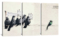 a group of birds sitting on top of a white wall