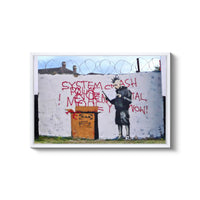 a picture of a man standing in front of a wall with graffiti on it