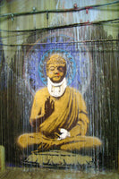 a painting of a buddha sitting in front of a wall