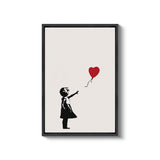 a black and white picture of a girl holding a red balloon