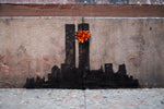 a flower is placed on the side of a building