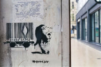 a sticker of a bear on a wall next to a building