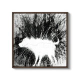 a black and white photo of a sheep in the woods