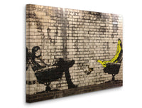 a brick wall with a painting of a man sitting on a bench and a banana